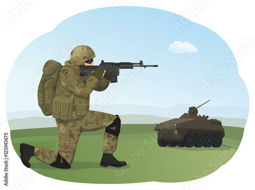 Soldier in uniform is standing on one knee and ready to fight. Shooting training. Armored troop carrier on the background.