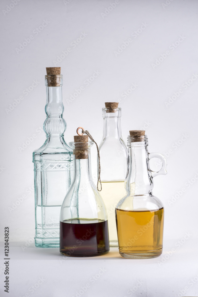 Transparent glass bottle with oil and vinegar on white background. Transparent glass bottle with oil and vinegar on white background.