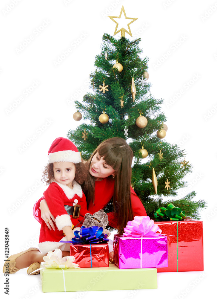 Mother with daughter near the Christmas tree Mother with daughter near the Christmas tree