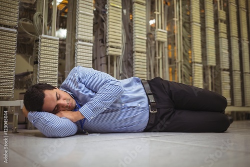 Tried technician sleeping on tiled floor © WavebreakmediaMicro