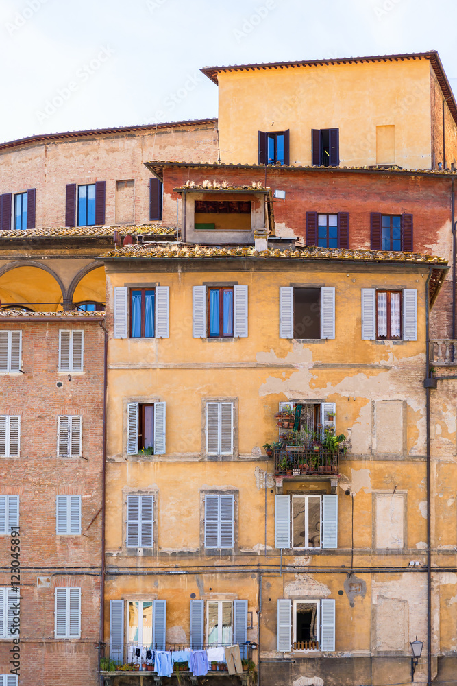 Fototapeta premium Old residential building with balconies in Italy
