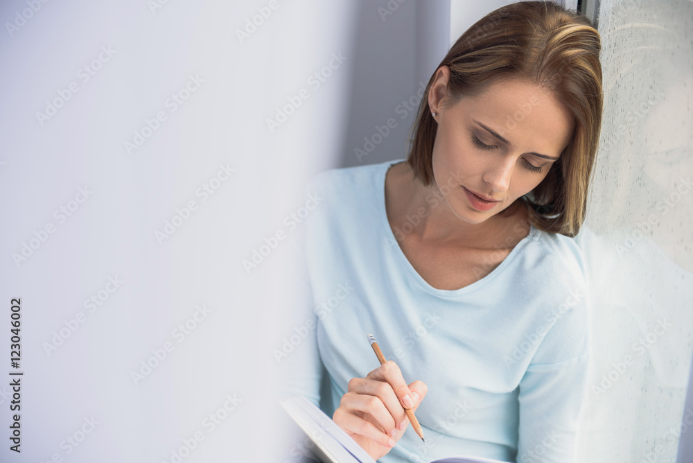 lonely lady drawing in front of the window lonely lady drawing in front of the window