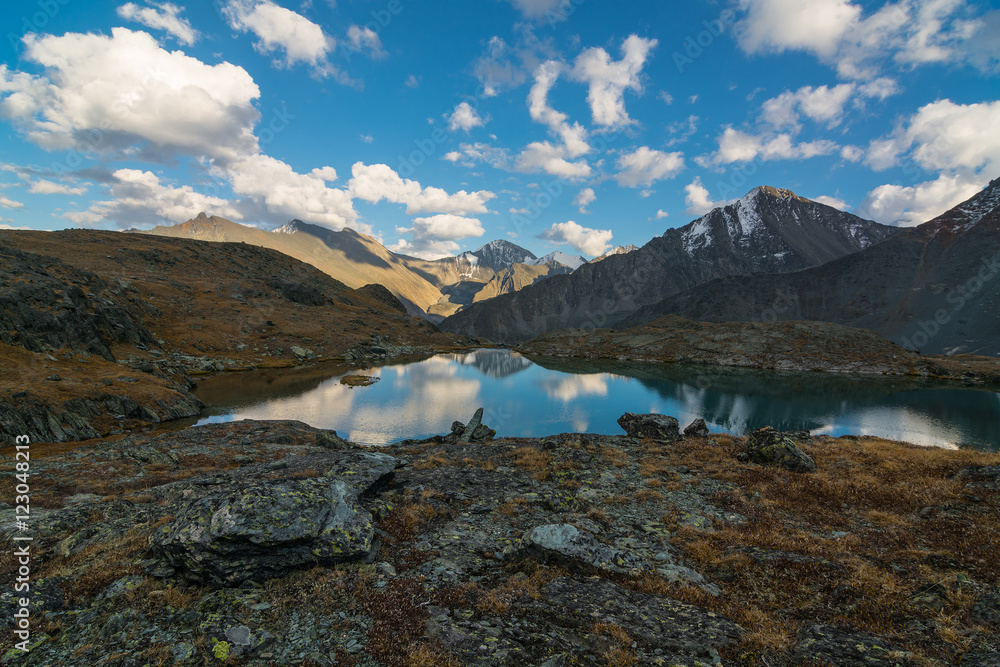 Reflection of clouds in the mountainous lake. Valley of seven lakes, Gorny Altai, Russia.