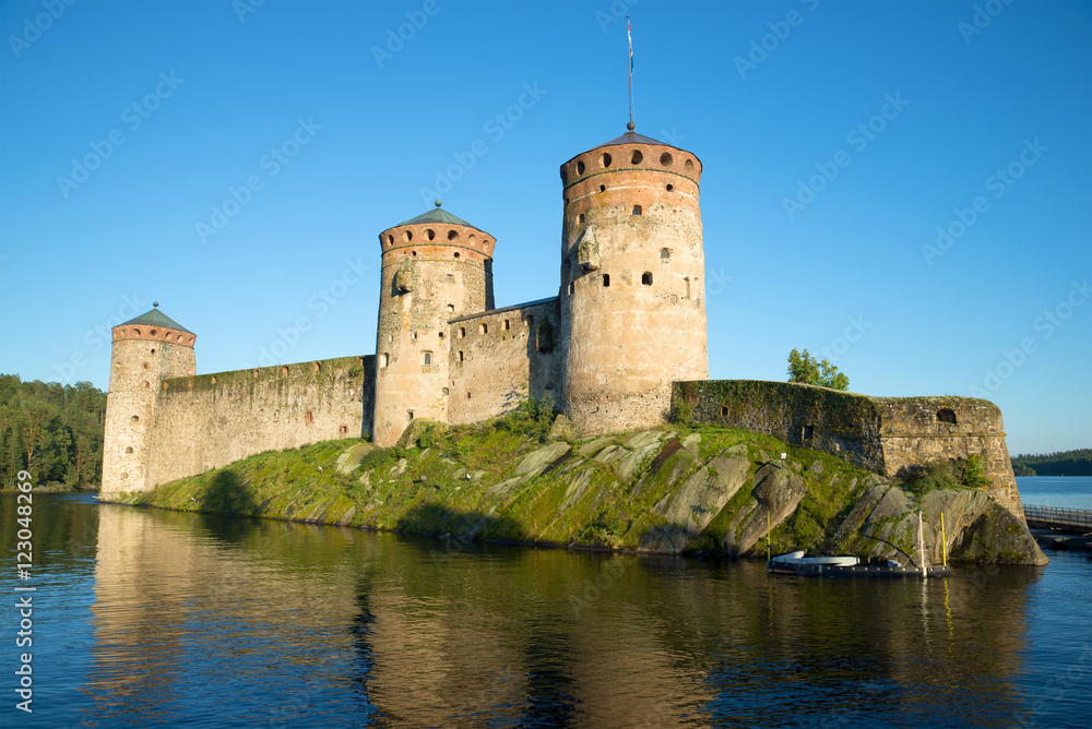 Olavinlinna fortress in the rays of the setting sun on  august evening. Savonlinna, Finland