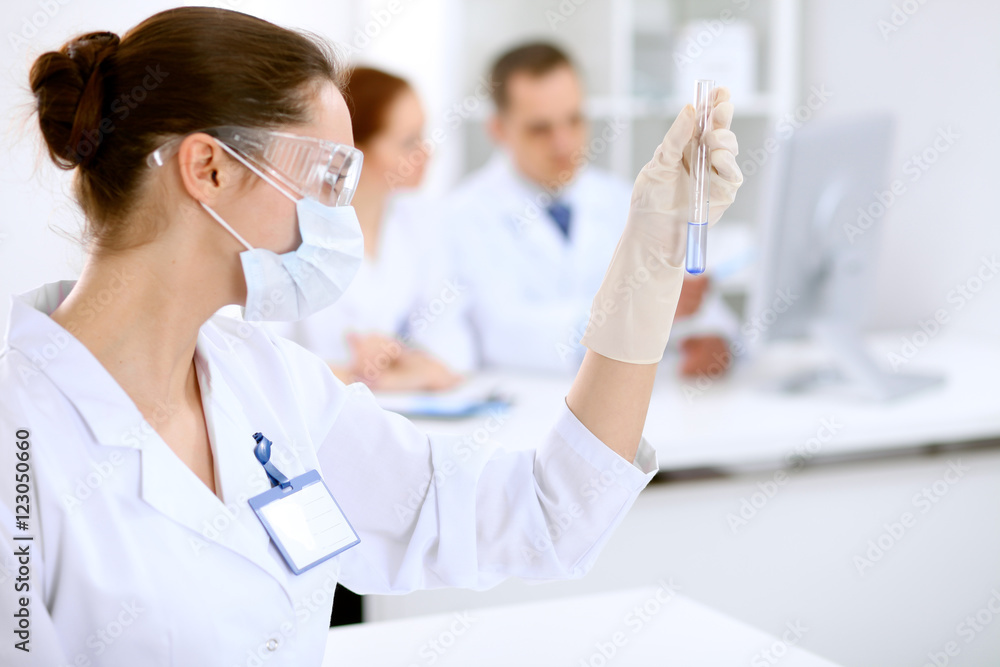 Scientific research team with clear solution in laboratory Scientific research team with clear solution in laboratory
