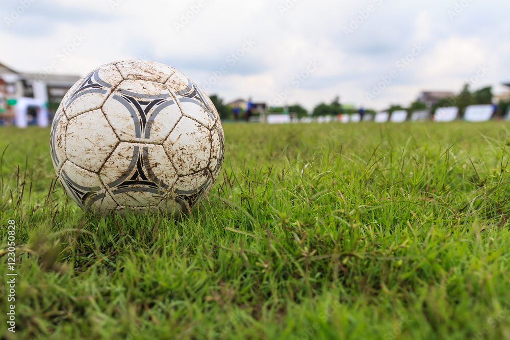 Fototapeta premium Nakhon Ratchasima, Thailand - October 1 : Muddy soccer ball on a football field in Municipal Stadium Nakhon Ratchasima on October 1, 2016, in Thailand.