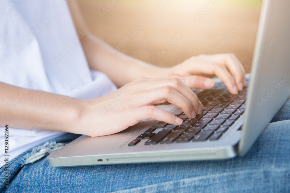 Naklejka premium Hands of a woman working with computer,outdoor.