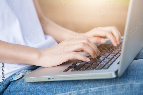 Hands of a woman working with computer,outdoor.