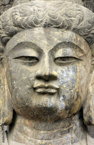   Stone old statue of a Buddha. Face close up   Face Buddha stat