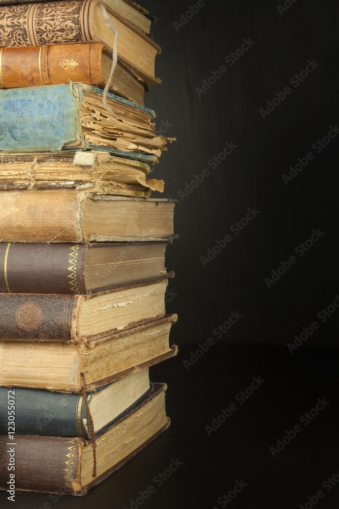 Stack of old books, copyspace for your text. Antique books on old wooden shelf.
Stack of old books, copyspace for your text. Antique books on old wooden shelf.