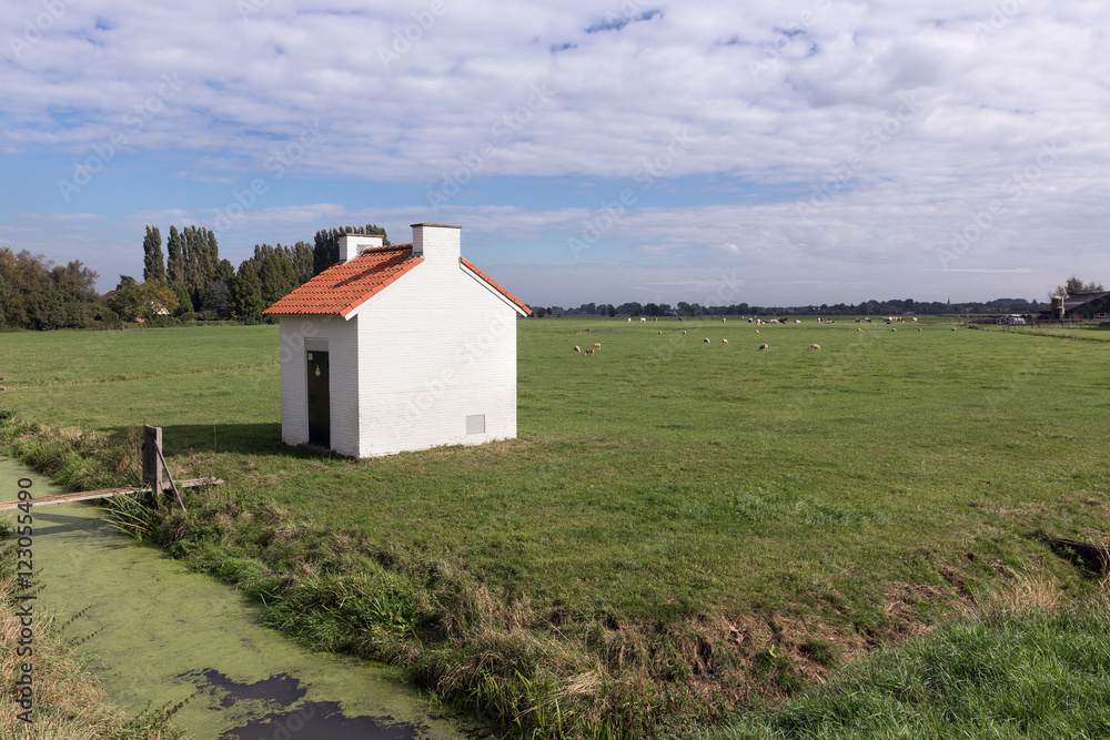 Little house with electricity equipment in Dutch landscape