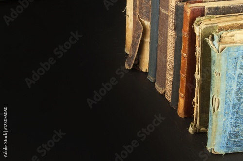 Stack of old books, copyspace for your text. Antique books on old wooden shelf.    © martinfredy