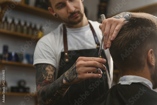 barber cutting hair of a man