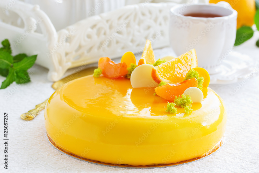 Cake with orange mousse and almond krokantom in the mirror glaze. Selective focus. Cake with orange mousse and almond krokantom in the mirror glaze. Selective focus.
