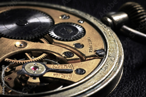 Pocket watch inside with wheels and springs close up photo