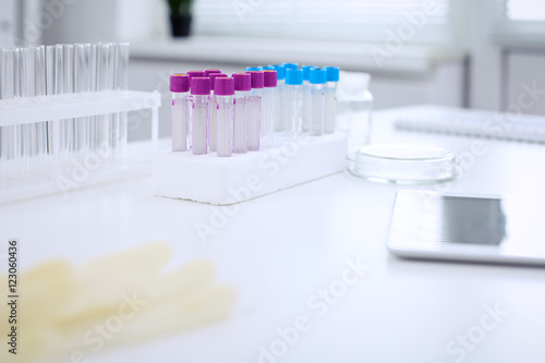 Research laboratory working space. Test tubes and tablet PC are lying at the table. Medical equipment. Blood test