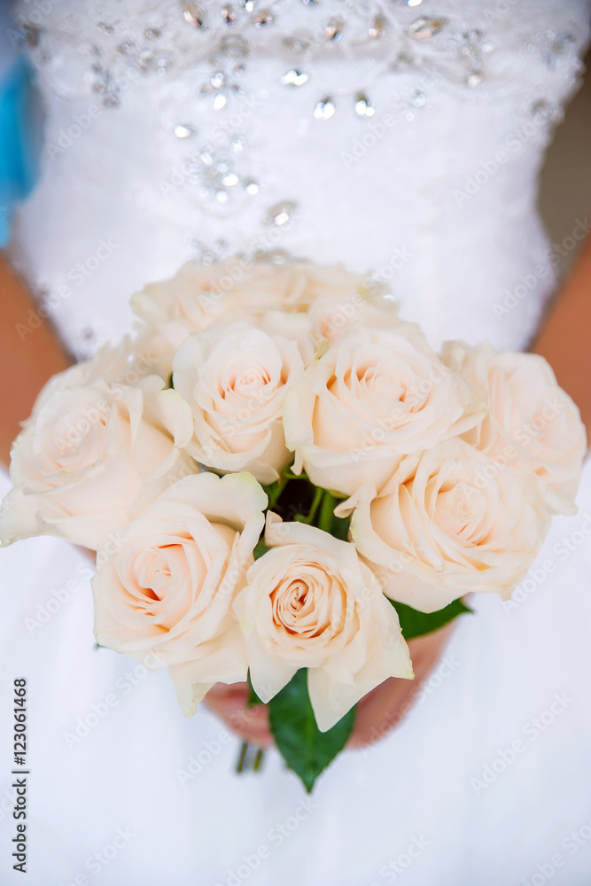 Beautiful bride with pink roses bouquet. Close up of pink roses bouquet held by a bride Beautiful bride with pink roses bouquet. Close up of pink roses bouquet held by a bride