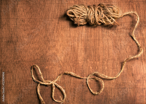 wooden background with a skein of twine