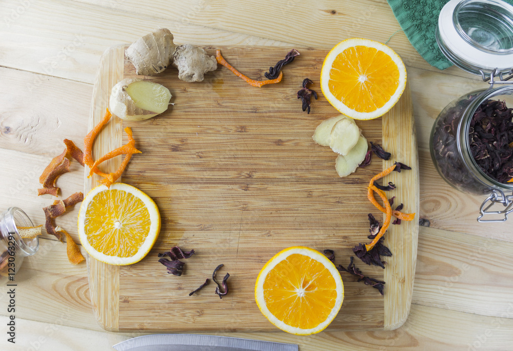 Hot tea with orange and ginger on a wooden Board Hot tea with orange and ginger on a wooden Board