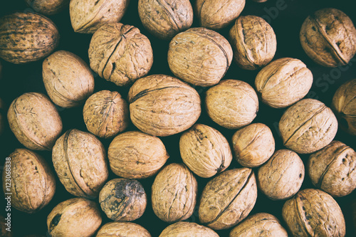 many walnuts lie on a black background