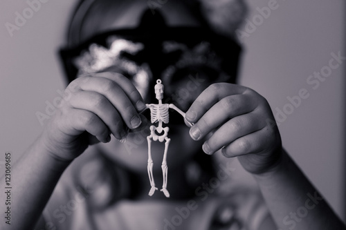 A skeleton, a girl, and a candle. Black and white.