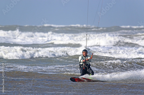 kitesurfer riding in waves