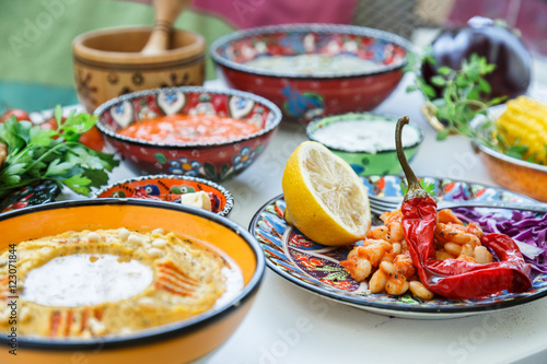 Mediterranean traditional meze: hummus, babaganoush, harissa, tzatziki on white background
