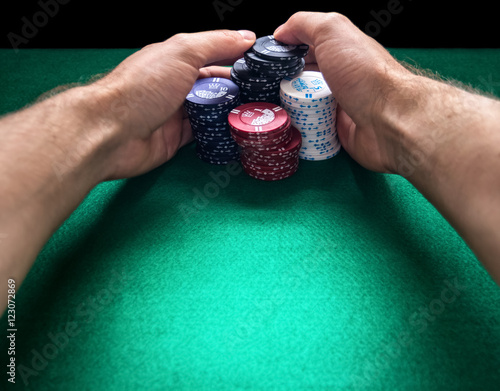 Hände umklammern einen Stapel Pokerchips. photo