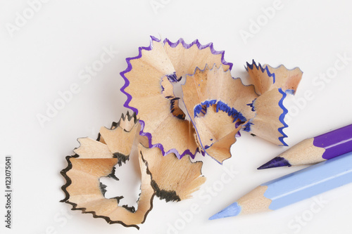 blue and purple pencil with colorful shavings on a white background texture close-up macro