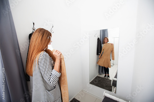 Vászonkép Woman with dress in the checkroom