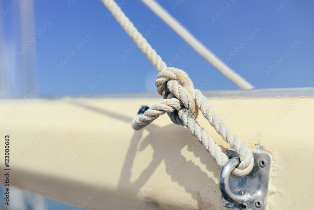 Closeup view of ship rope tackles on sunny blue sky background outdoors