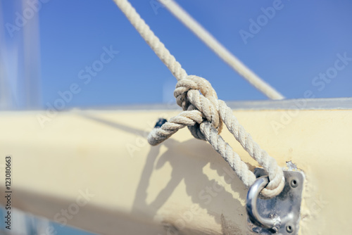 Closeup view of ship rope tackles on sunny blue sky background outdoors