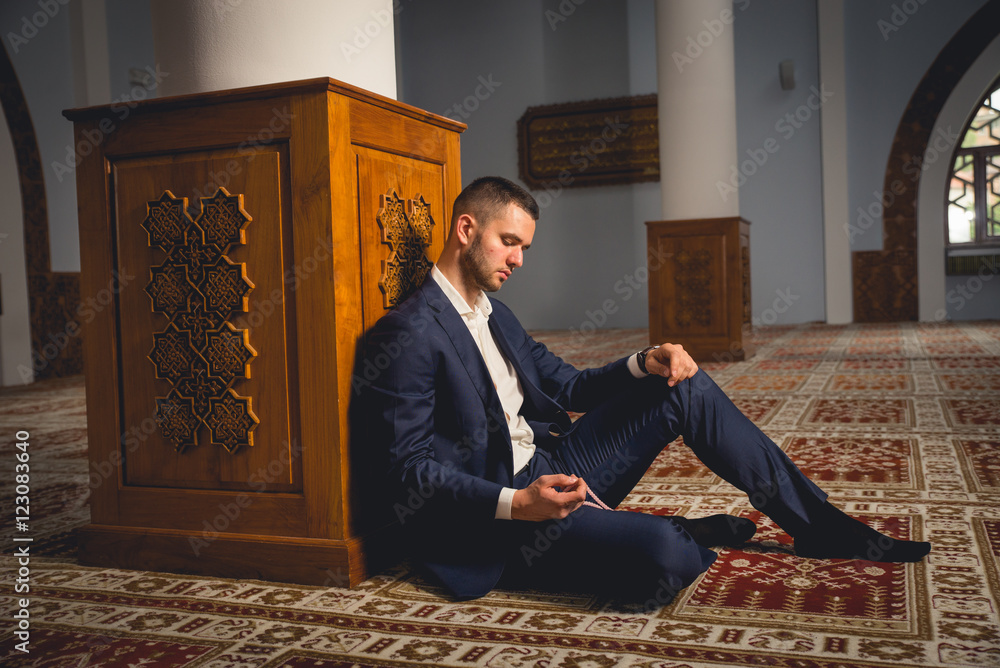 Young Muslim praying in a mosque. Young Muslim praying in a mosque.