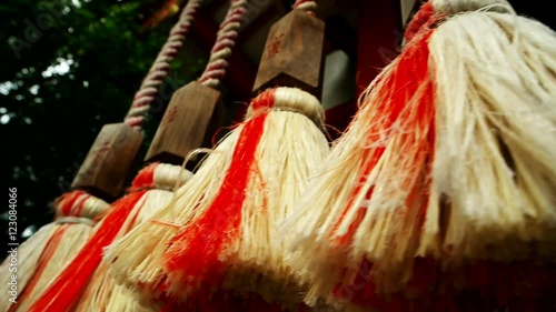 Shinto temple bell ropes with straw ends. Slow motion point of view shot. Dazaifu 2016