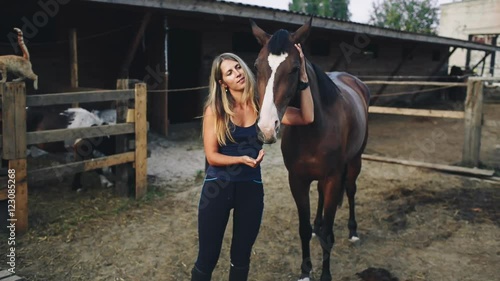 Woman Feeding a Horse an Apple on the Farm