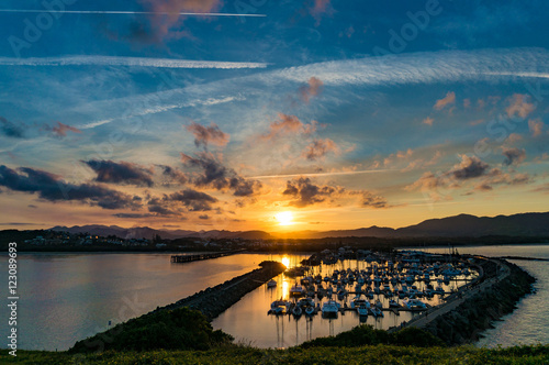 Sunset landscape of coastal city with dramatic clouds and plane trails on the background. Muttonbird Island Nature Reserve, Coffs Harbour, Australia photo