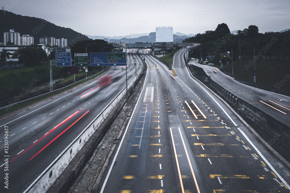 People busy commuting with cars using highway between cities.