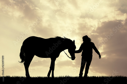 girl with horse silhouette at sunset