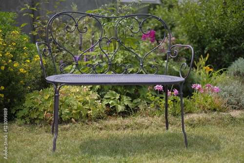 jardin et banc en fer forgé photo