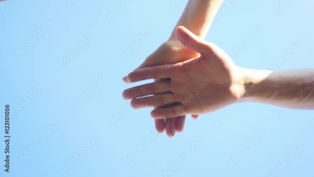 Successful team: many hands holding together on sky background in slowmotion. 1920x1080 Successful team: many hands holding together on sky background in slowmotion. 1920x1080