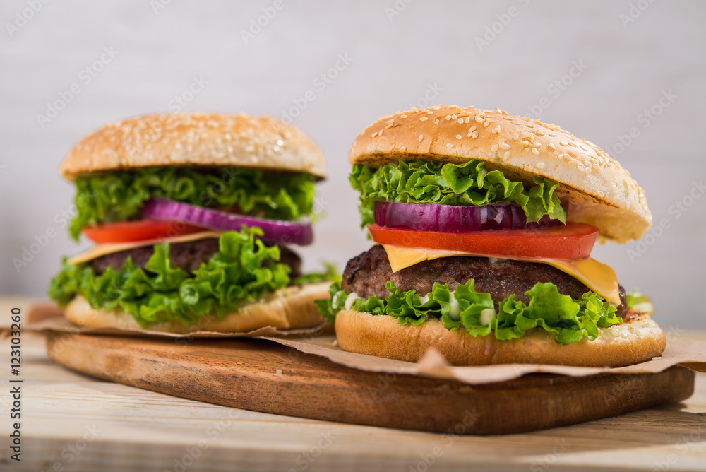 burgers on wooden table burgers on wooden table
