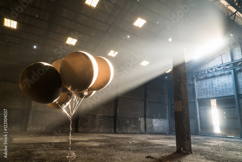Black balloon with sunlight and shadow in a deserted godown