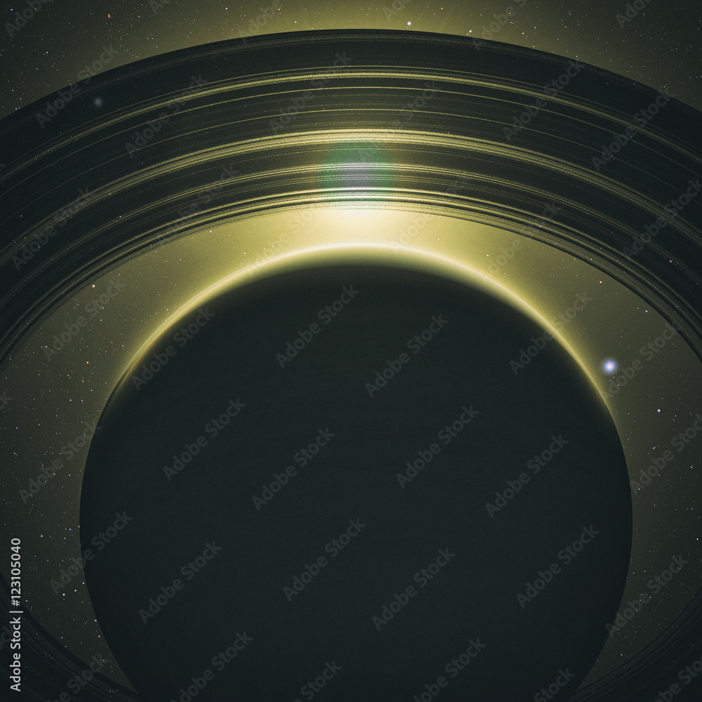 Fototapeta premium planet saturn with rings at sunrise on the space background