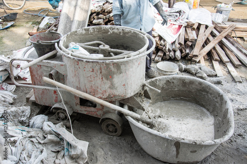 mixing ingredients in the concrete mixer at building site © Suwatchai