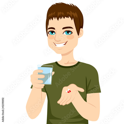 Young attractive man taking pills with glass of water