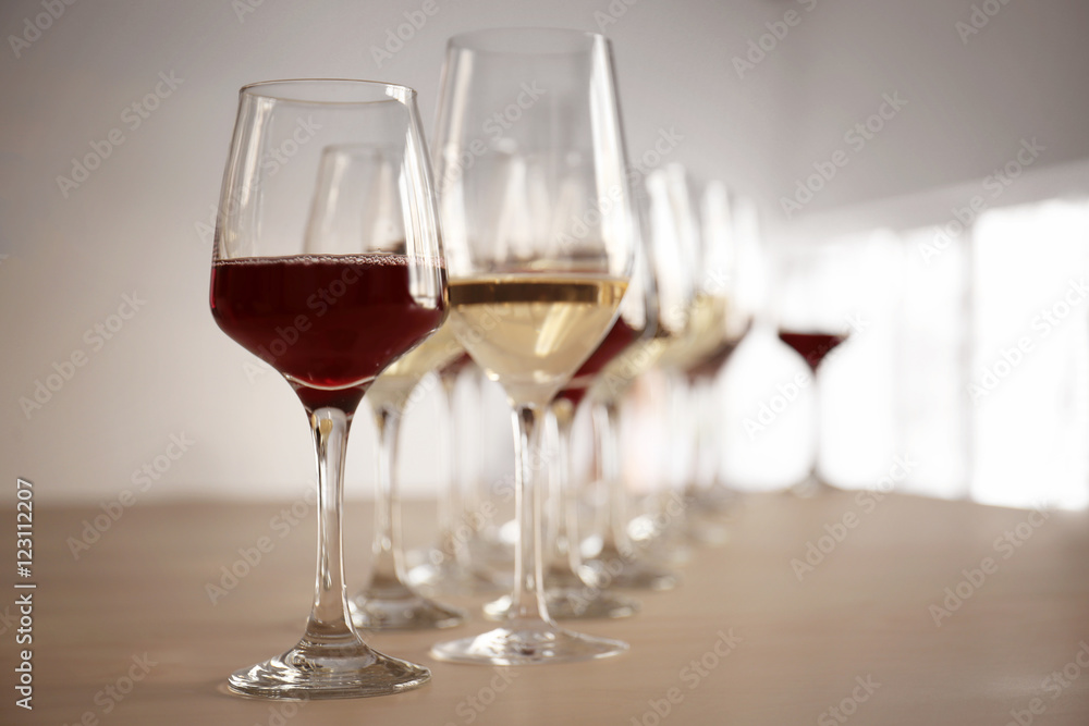 Glasses with red and white wine on table in restaurant Glasses with red and white wine on table in restaurant