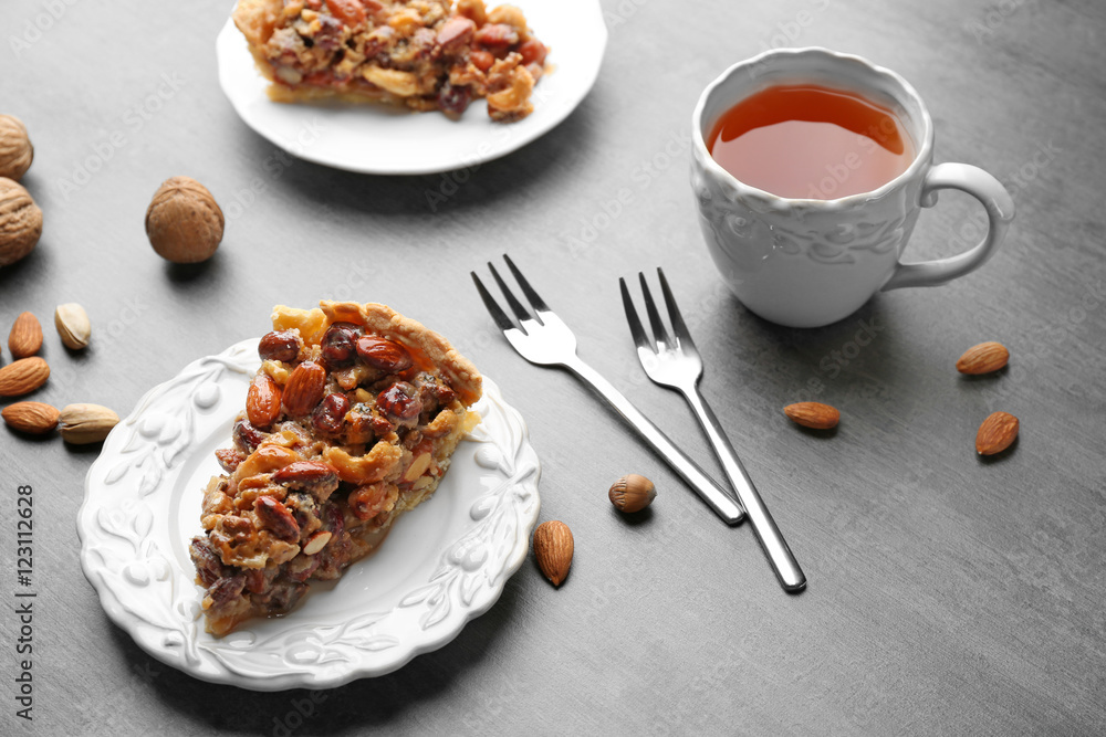 Cup of tea and tasty tart on table