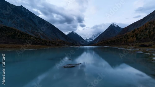 Time Lapes. Belukha Mountain and Highland Lake Akkem in autumn before sunrise. Altay Mountains, Russia.