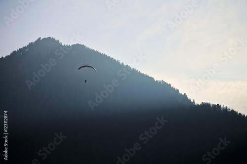 Paragliding through mountains in Dolomites, Italy