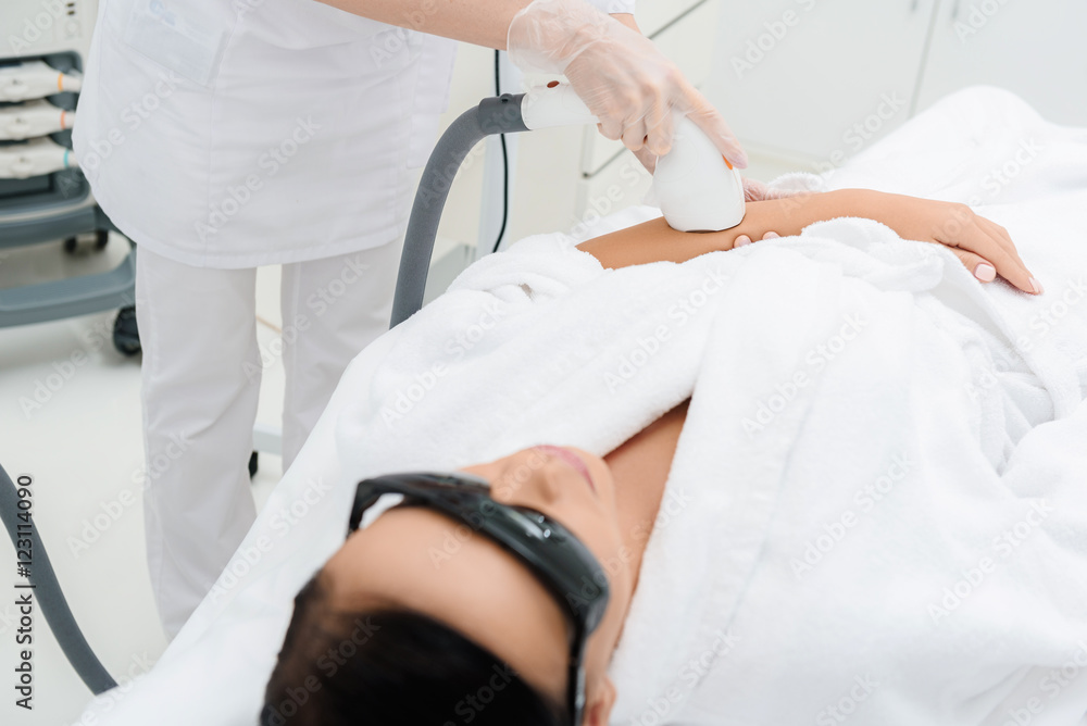 Professional cosmetologist doing ultrasound massage Professional cosmetologist doing ultrasound massage